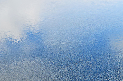 "Hovering over the face of the waters," one can imagine the deep darkness below. And yet, the blue sky reflects upon the surface. This variability in the nature of water allows for multiple perspectives in the music.